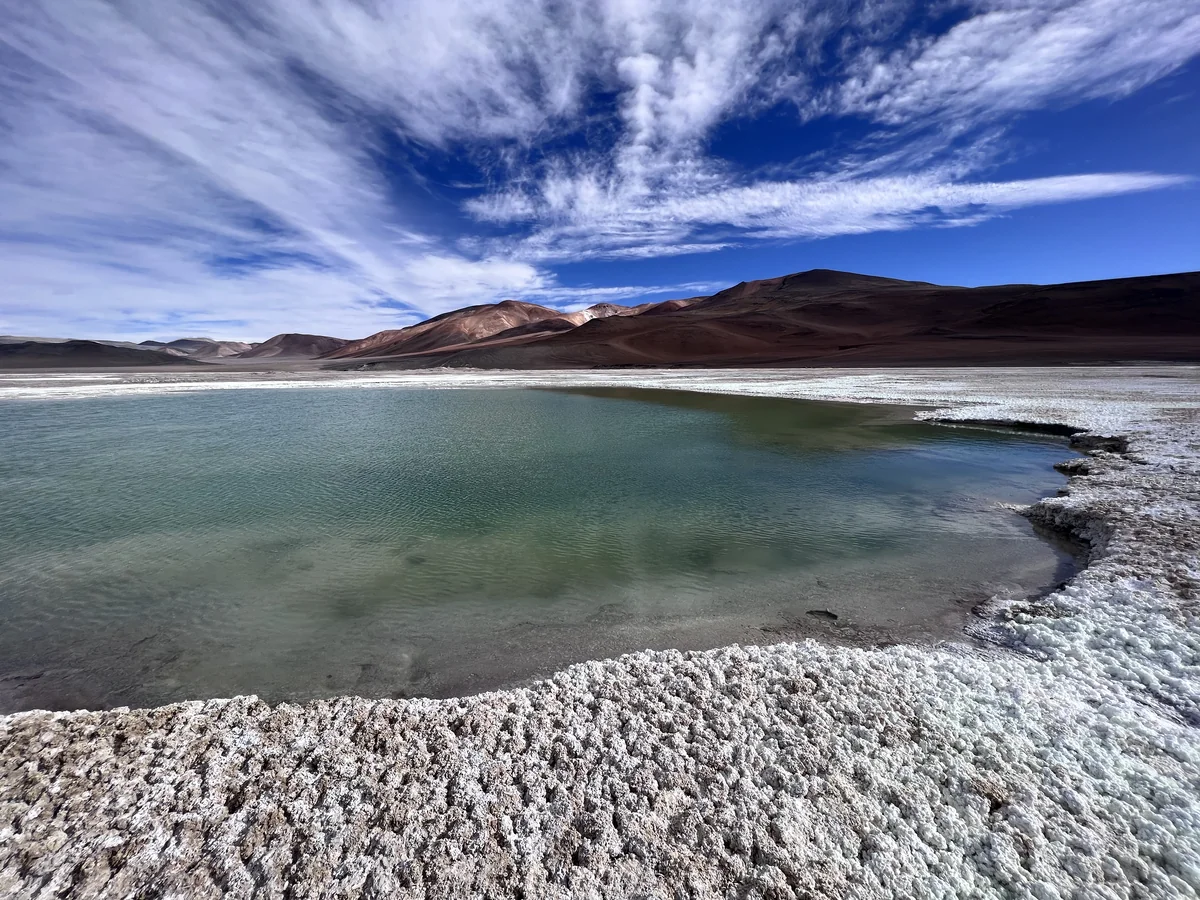 Mountain lagoon surrounded by mineral deposits